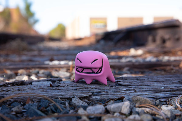 pink Mr. Fangs acrylic toy figurine out and about on the tracks
