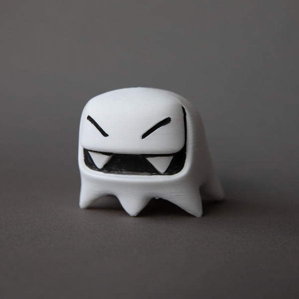white Mr. Fangs acrylic figurine with black eyes and mouth